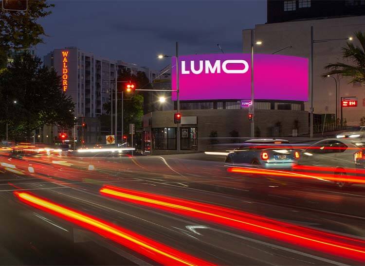 A LUMO digital billboard lit above Anzac Avenue, Auckland, at night.